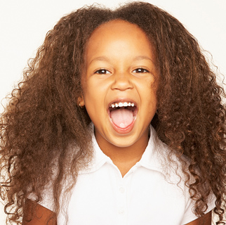 Little girl with her mouth wide open pretending to bite.