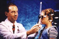 Picture of a physician using a prism to check for strabismus