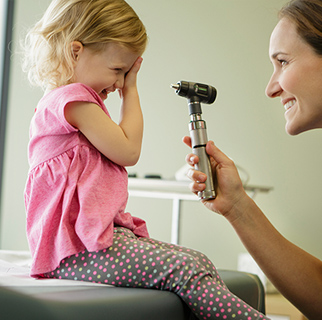 Toddler having a well care visit at the pediatrician.