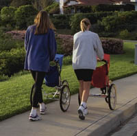 Picture of two mothers walking with jogging strollers