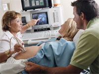 Picture of a physician performing an ultrasound on an expectant mother