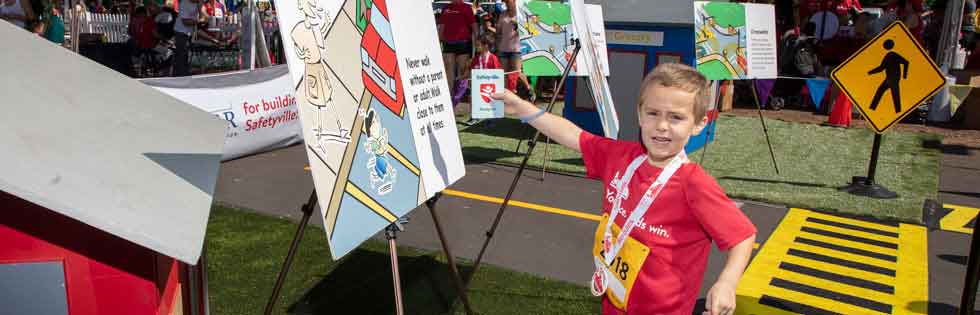 Boy holding up Safetyville passport