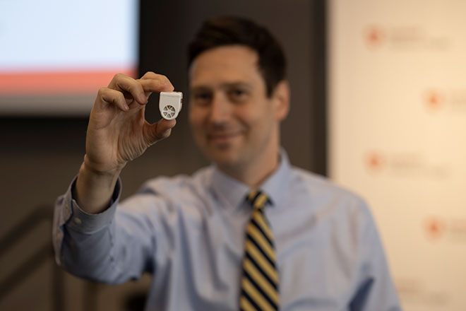 David Conrad, MD, with his device, Beacon