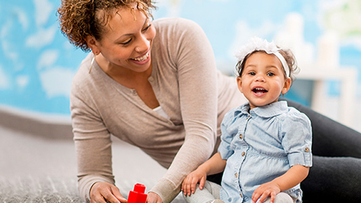 Young mother with her smiling baby