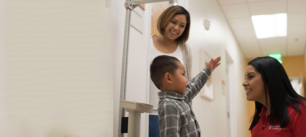 Stanford Medicine Children's Health patient having height and weight being measured