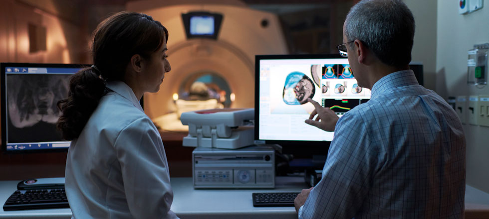 Female and male doctor looking at scan